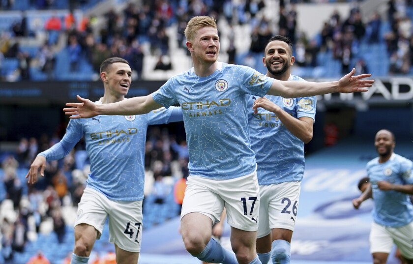 FILE - In this Sunday, May 23, 2021 file photo, Manchester City's Kevin De Bruyne, centre, Manchester City's Phil Foden, left, and Manchester City's Riyad Mahrez celebrate scoring their side's first goal during the English Premier League soccer match between Manchester City and Everton at the Etihad stadium in Manchester. De Bruyne has been voted England’s player of the season by his fellow professionals for a second consecutive year after helping his team regaining the Premier League trophy. The Belgium international is only the third man to retain the Professional Footballers' Association trophy after Thierry Henry in 2003 and 2004 while playing for Arsenal, and Cristiano Ronaldo in 2007 and 2008 during his Manchester United career. (AP Photo/Dave Thompson, Pool, File)
