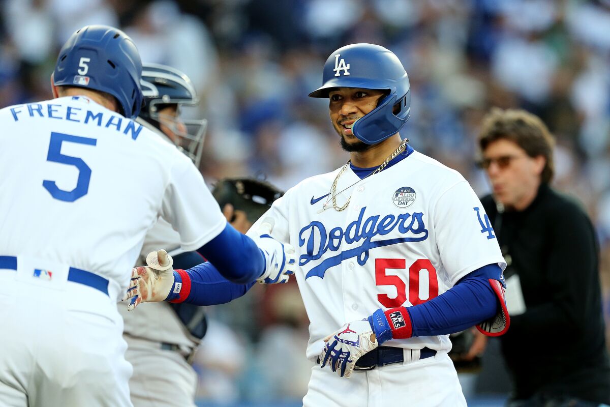 Dodgers right fielder Mookie Betts is congratulated by Dodgers first baseman Freddie Freeman.