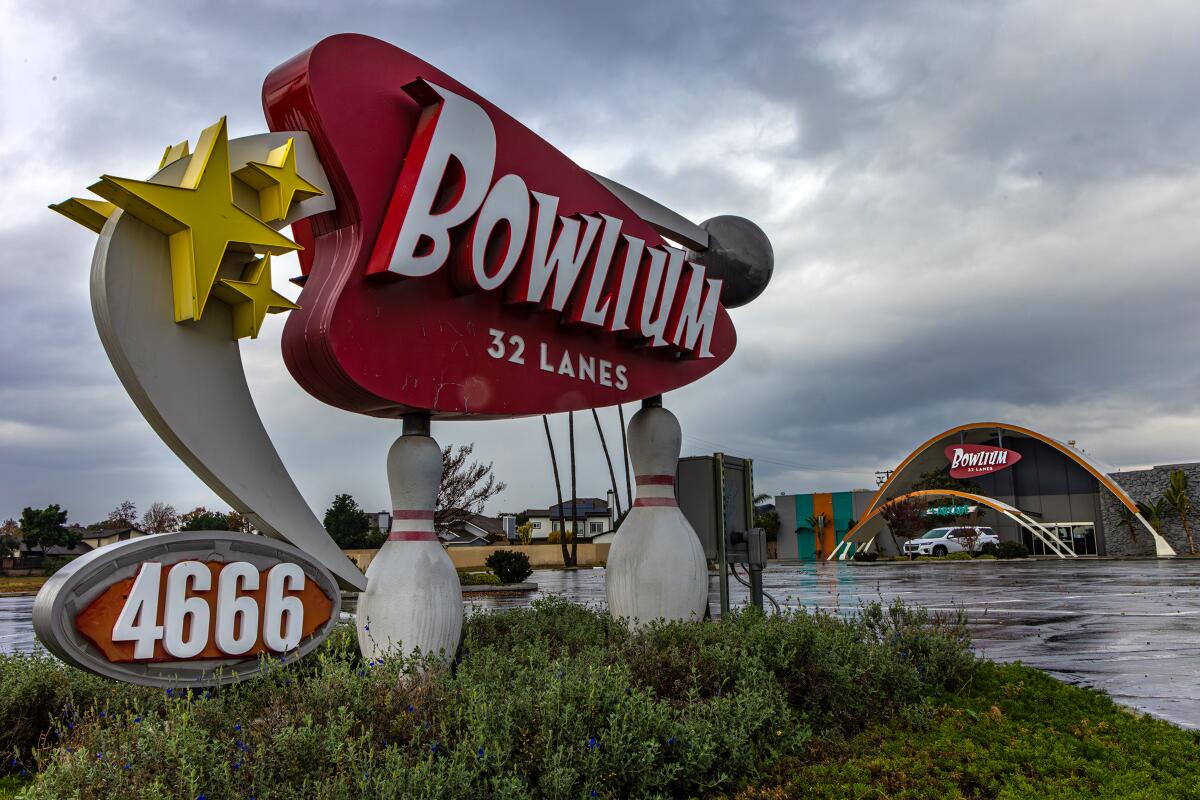 A structure that has the words "Bowlium 32 Lanes" on it.