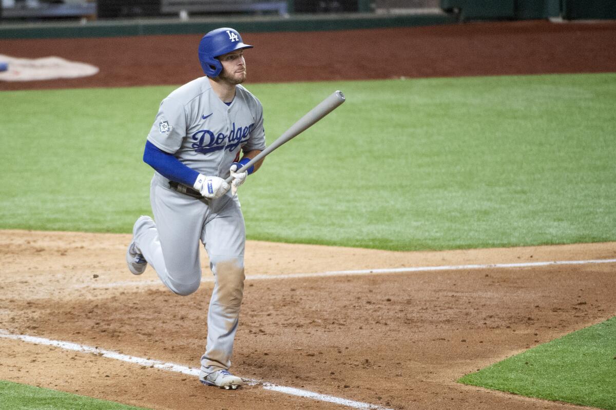 The Dodgers' Max Muncy watches the flight of his three-run homer in the seventh inning against Texas on Aug. 29, 2020.