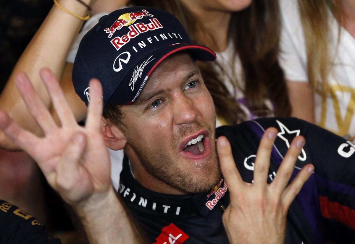 Red Bull driver Sebastian Vettel celebrates his fourth consecutive Formula One drivers' title following his win Sunday in the Indian Grand Prix.