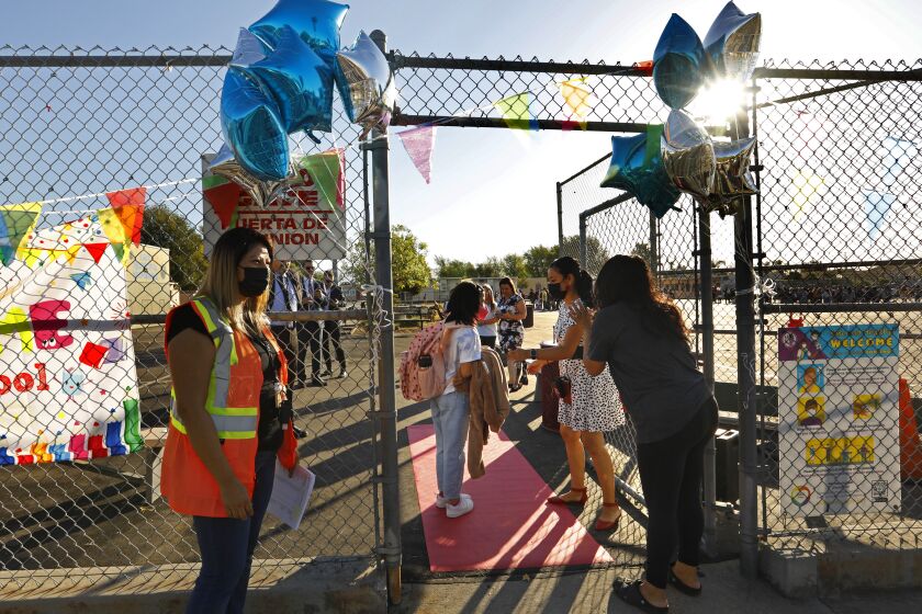 Los Angeles, Arleta, California-Aug. 15, 2022-Parents say goodbye and watch as their students enter Vena Avenue Elementary & Gifted/High Ability Magnet in Arleta, CA on the first day of classes Aug. 15, 2022. (Carolyn Cole / Los Angeles Times)