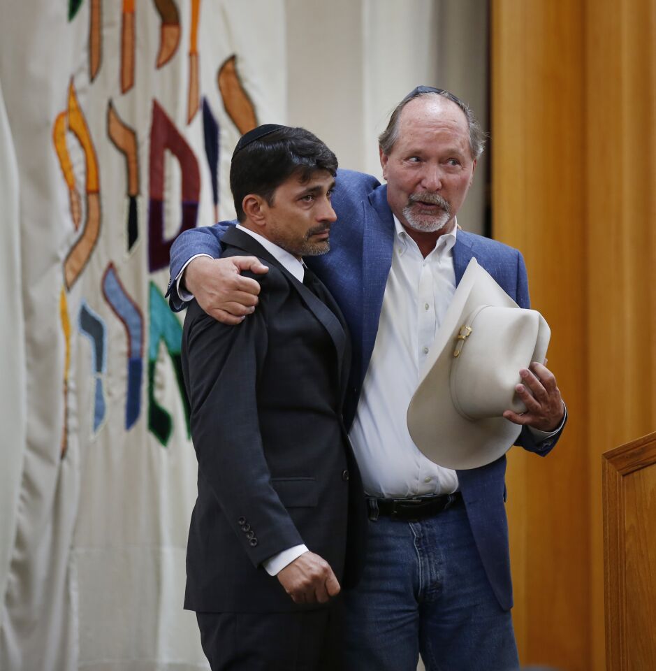 Oscar Stewart, left, who was called a hero in the Poway shooting, was called up by Poway Mayor Steve Vaus to lead God Bless America during a service for Lori Gilbert-Kaye, 60, at the Chabad of Poway on April 28, 2019 in Poway, California. Gilbert-Kaye was killed by a gunman at the synagogue.