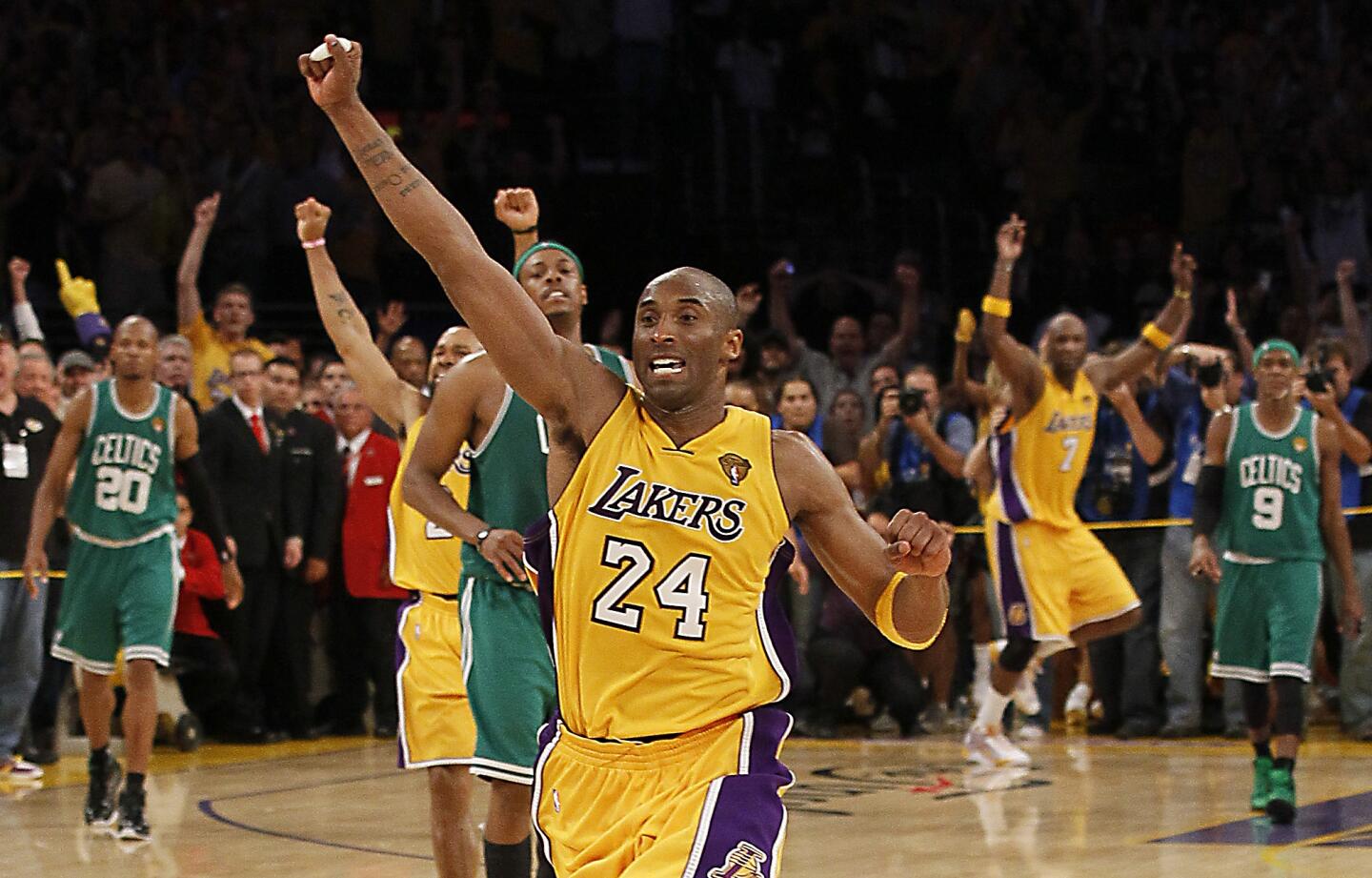 Kobe Bryant celebrates among other players on the court after the Lakers beat the Boston Celtics in the 2010 NBA Finals.