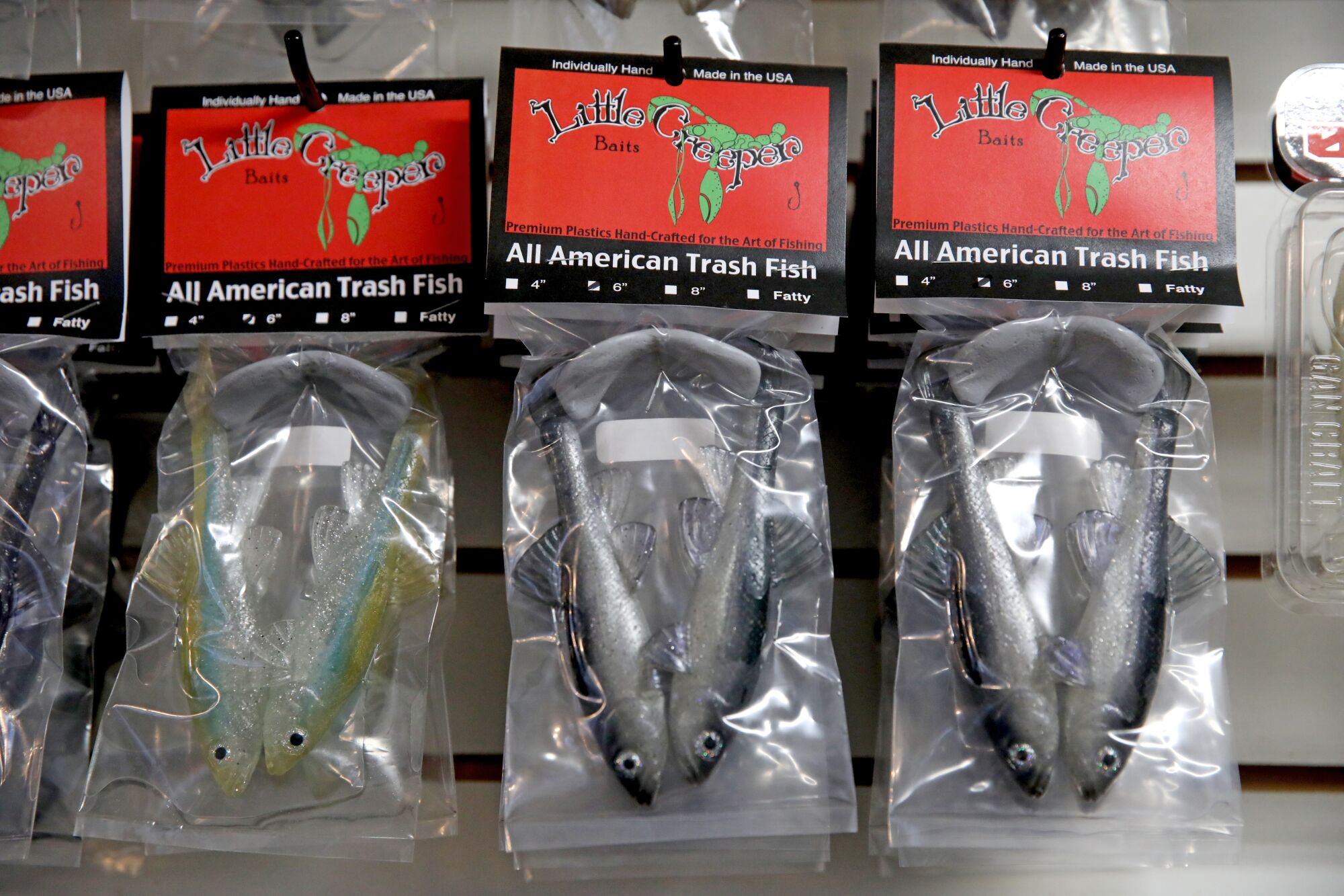 Fishing lures designed to look like hitch hang on a display rack.