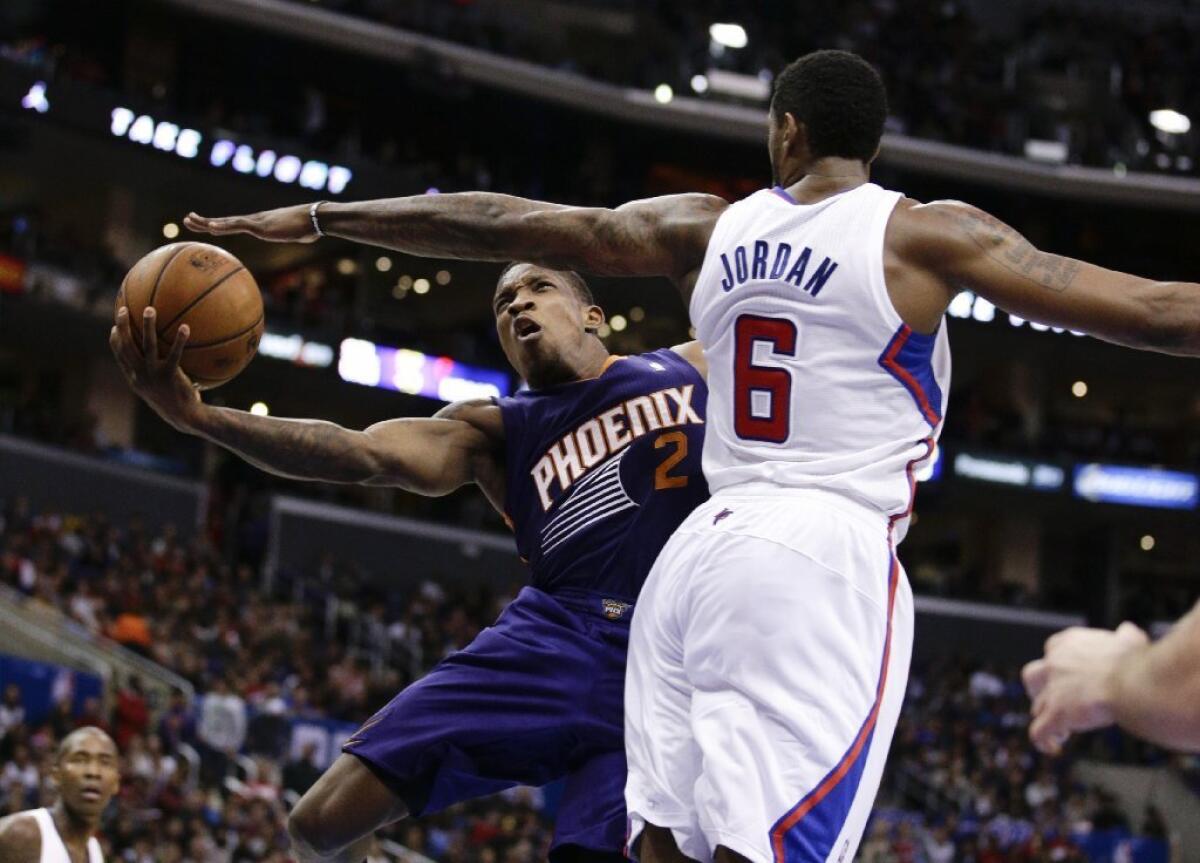 Phoenix Suns' Eric Bledsoe, left, puts up a shot against Clippers center DeAndre Jordan last season.