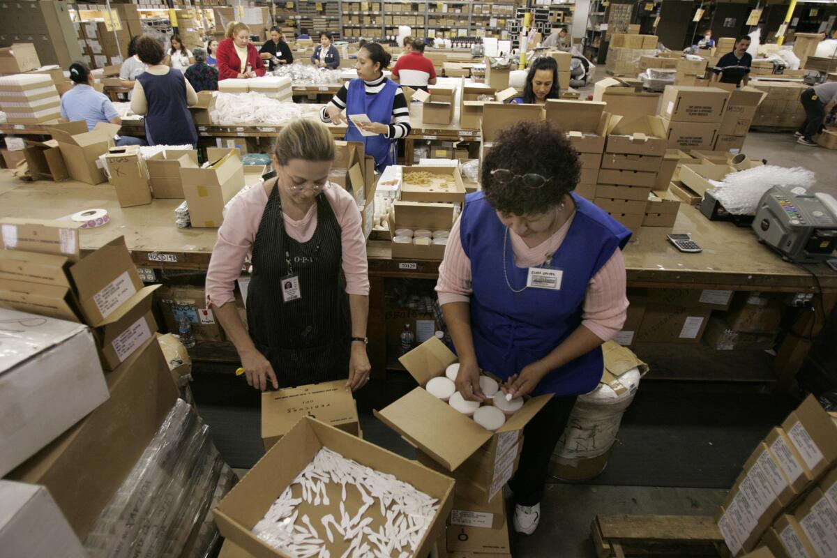 Rosa Aguilar, left, and Clara Ramos work at OPI Products in North Hollywood. The cosmetics maker took action to keep costs down for its workers saving for retirement.