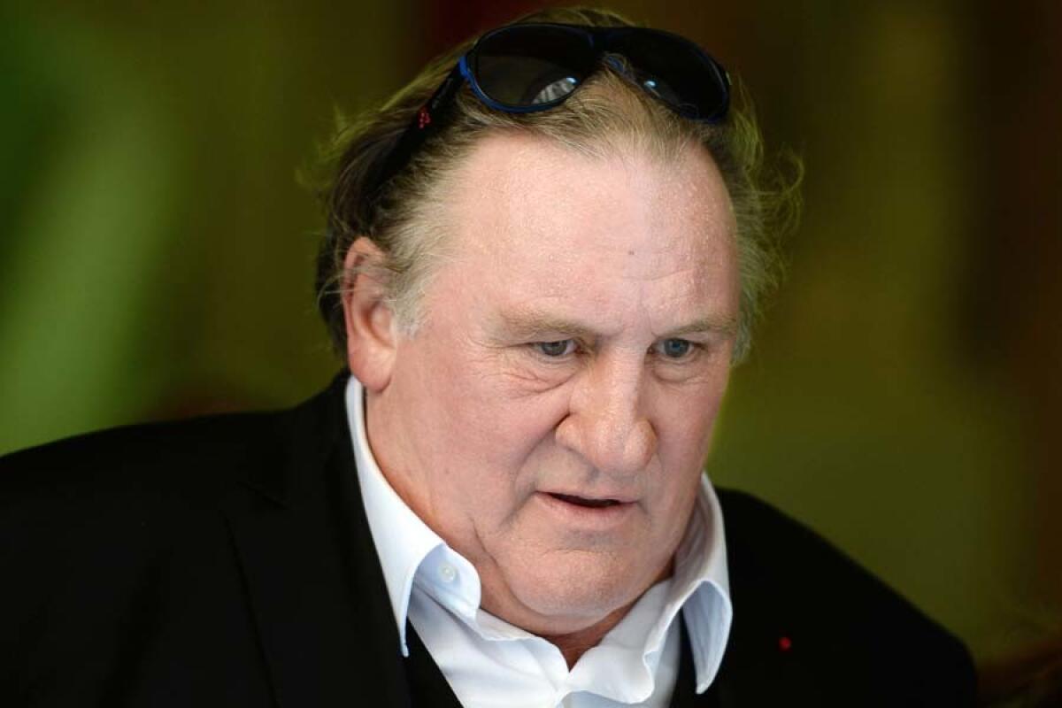 Gérard Depardieu with sunglasses resting on his head.