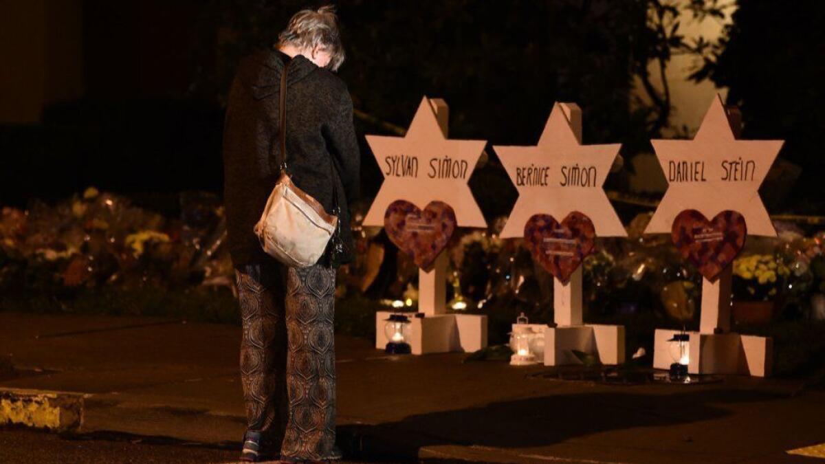 A woman in front of a memorial at the Tree of Life synagogue in Pittsburgh.