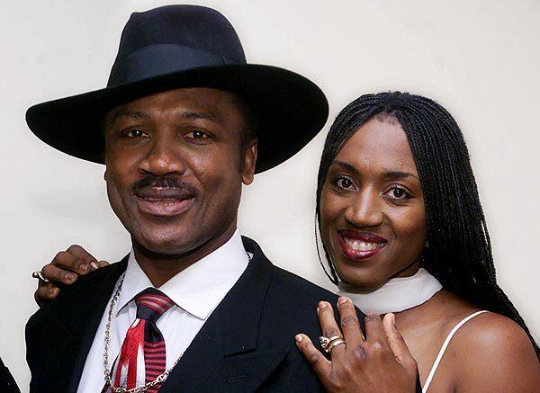 A retired Joe Frazier poses with his daughter, Jacqueline, also a boxer, at a 2000 screening in New York of "Ali-Frazier I: One Nation ... Divisible," a documentary about the historic boxing match and the cultural undercurrents that swirled around it.
