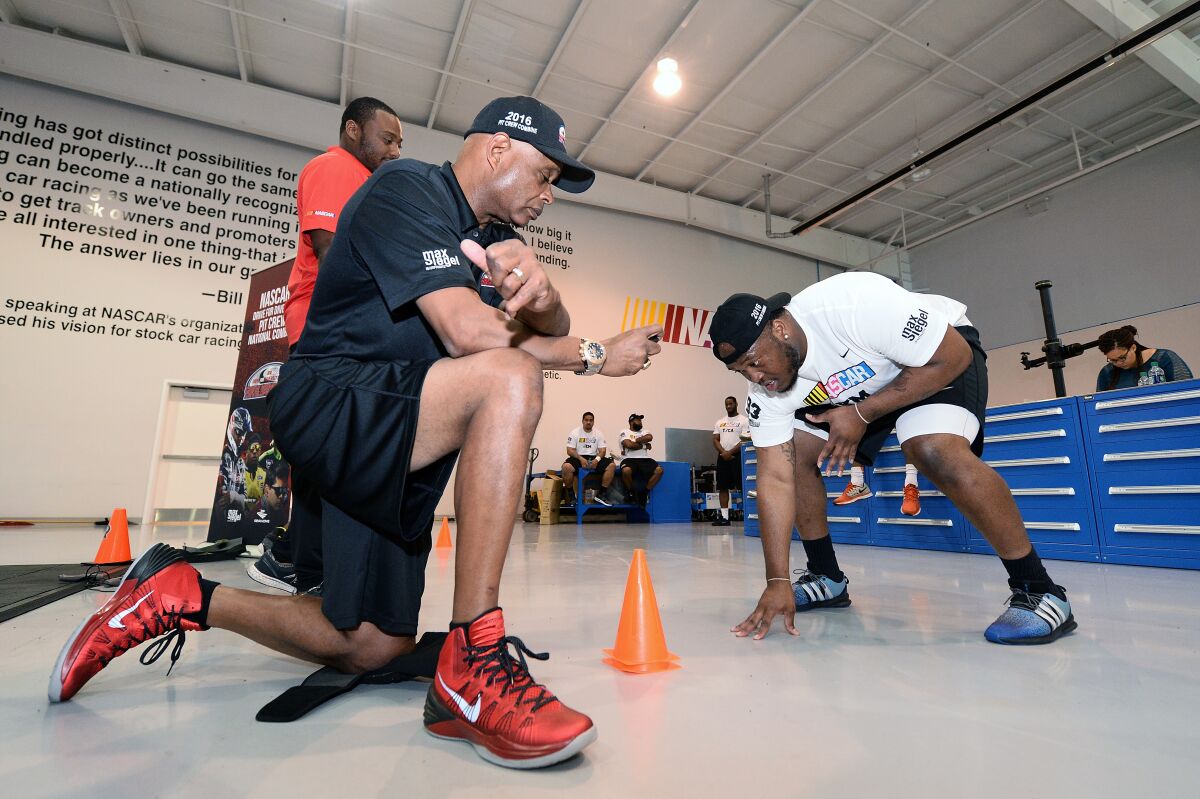 Phil Horton times a NASCAR Drive For Diversity participant during a pit crew combine in May 2016.