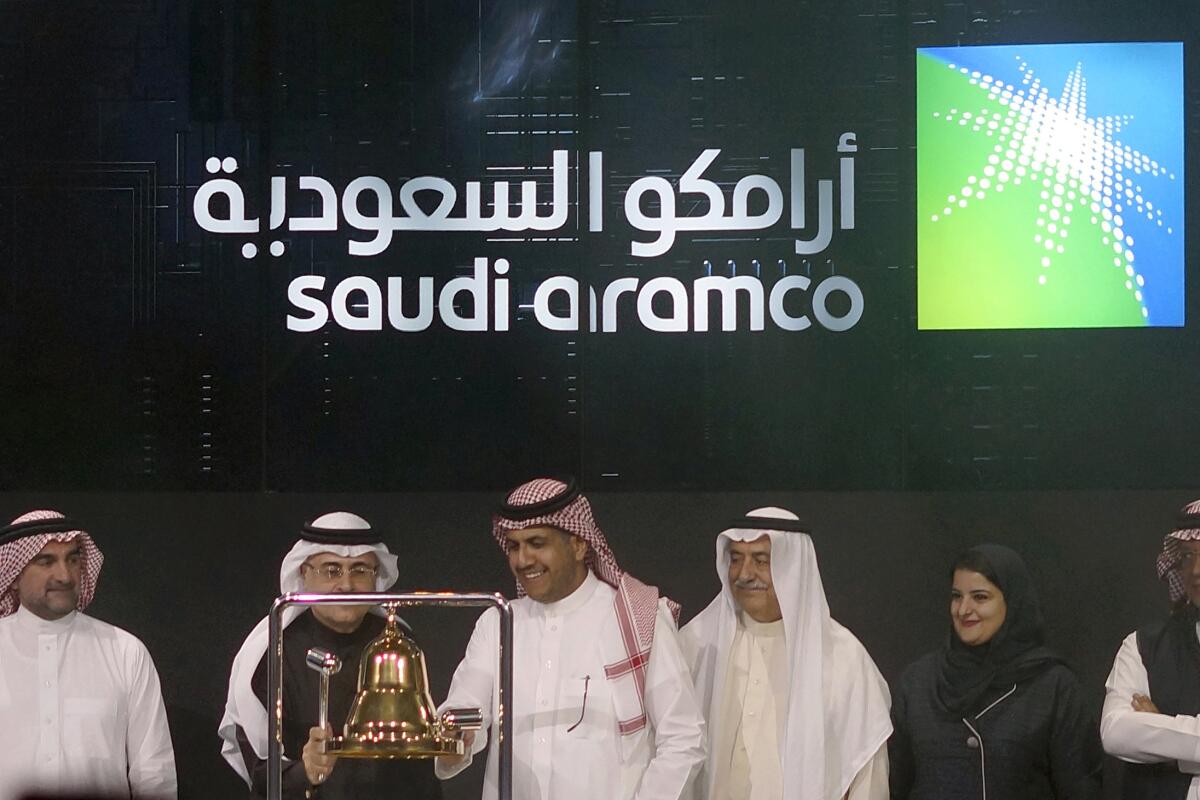 Officials celebrate the stock market debut of Saudi Aramco, Saudi Arabia's state-owned oil company, in Riyadh in December.