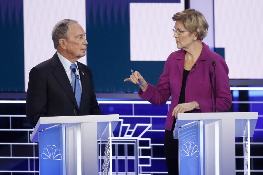 Democratic presidential candidates, former New York City Mayor Mike Bloomberg, left, and Sen. Elizabeth Warren, D-Mass., talk before a Democratic presidential primary debate Wednesday, Feb. 19, 2020, in Las Vegas, hosted by NBC News and MSNBC.
