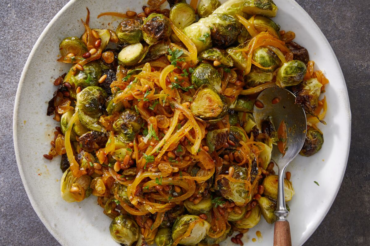 A dish of Brussels sprouts is enhanced with a sweet and sour dressing.