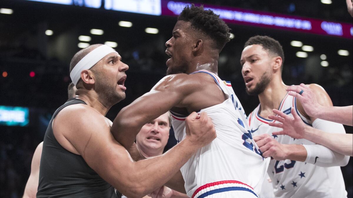 Brooklyn Nets forward Jared Dudley, left, and Philadelphia 76ers guard Jimmy Butler get into a shoving match before being ejected during the second half of the 76ers' win on April 20.