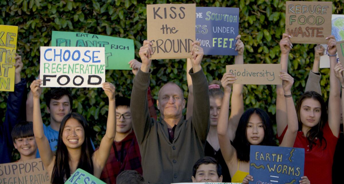 Woody Harrelson, center, is the narrator of the documentary "Kiss the Ground."