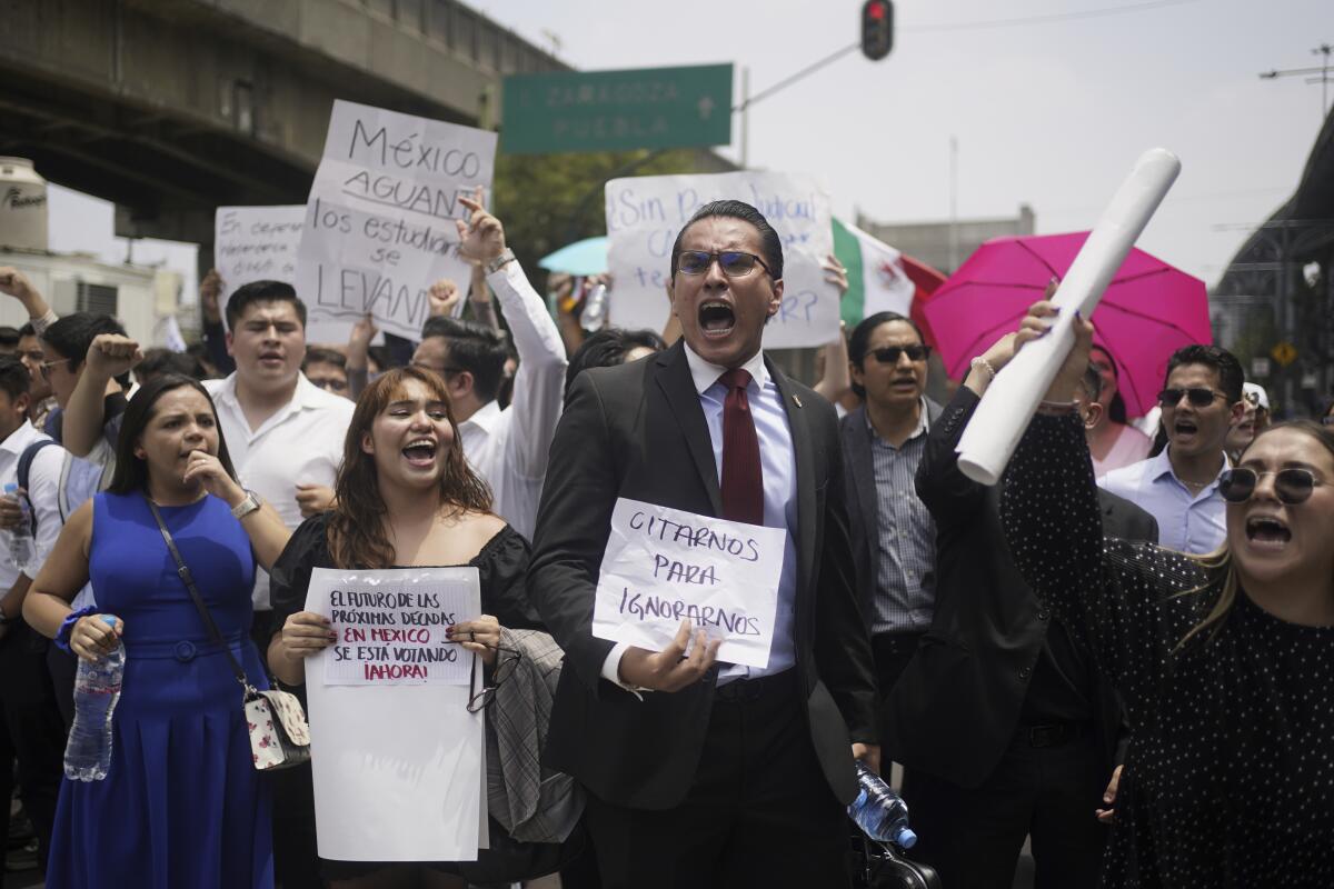 Students block a street in protest.