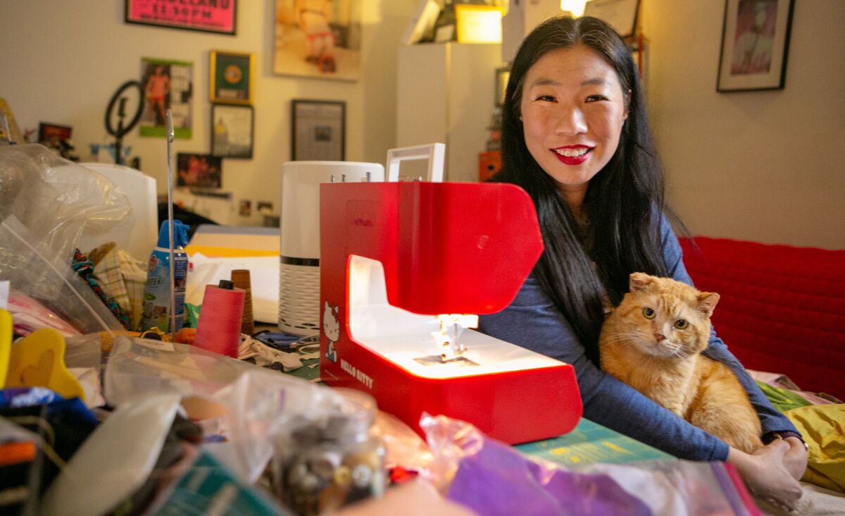 Performance artist Kristina Wong posed in March 2021 in the sewing room of her apartment in Koreatown, Los Angeles.