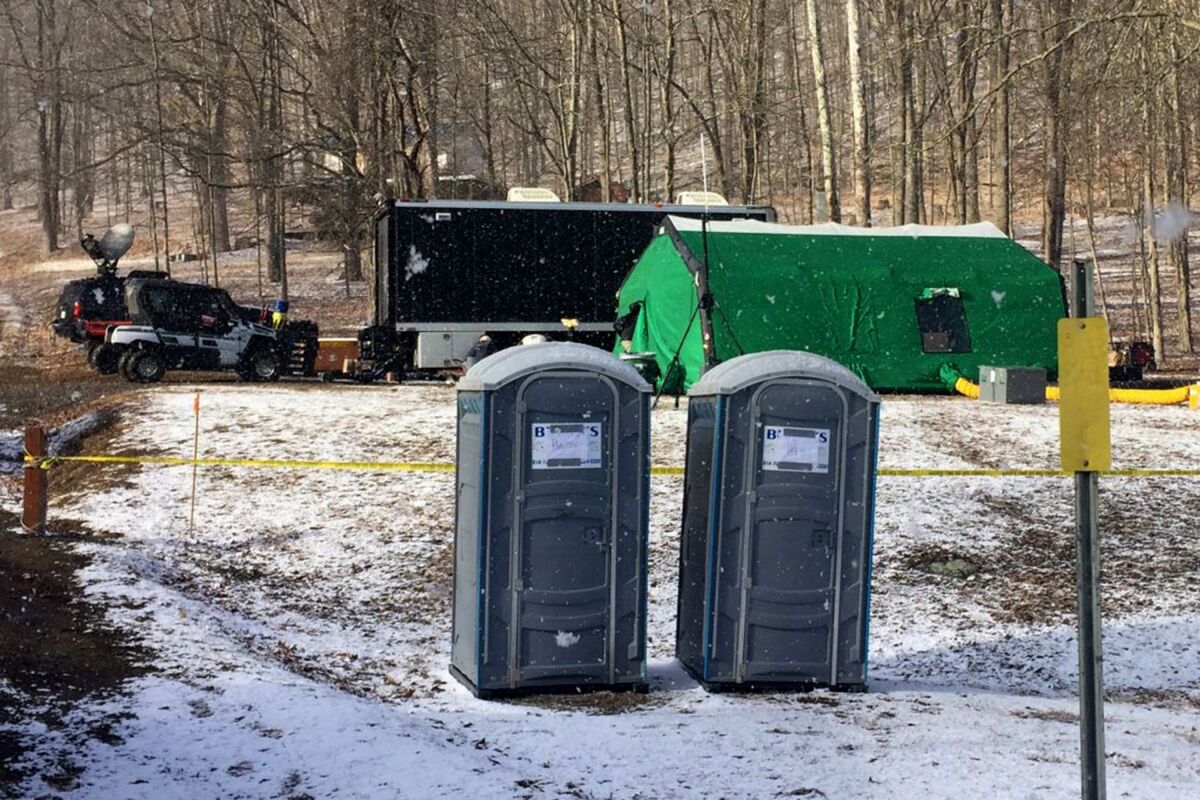 FILE - FBI agents and representatives of the Pennsylvania Department of Conservation and Natural Resources set up a base in March, 2018, in Benezette Township, Elk County, Pa. A lawyer for a father-son team of treasure hunters is accusing the FBI of either lying to a federal judge about having video of its 2018 dig for legendary Civil War-era gold, or illegally destroying the video. The FBI has acknowledged it was looking for gold at the Pennsylvania site but says it found nothing of value. The duo believes the FBI recovered a huge cache of gold and have sued for information about the dig. (Katie Weidenboerner/The Courier-Express via AP, File)