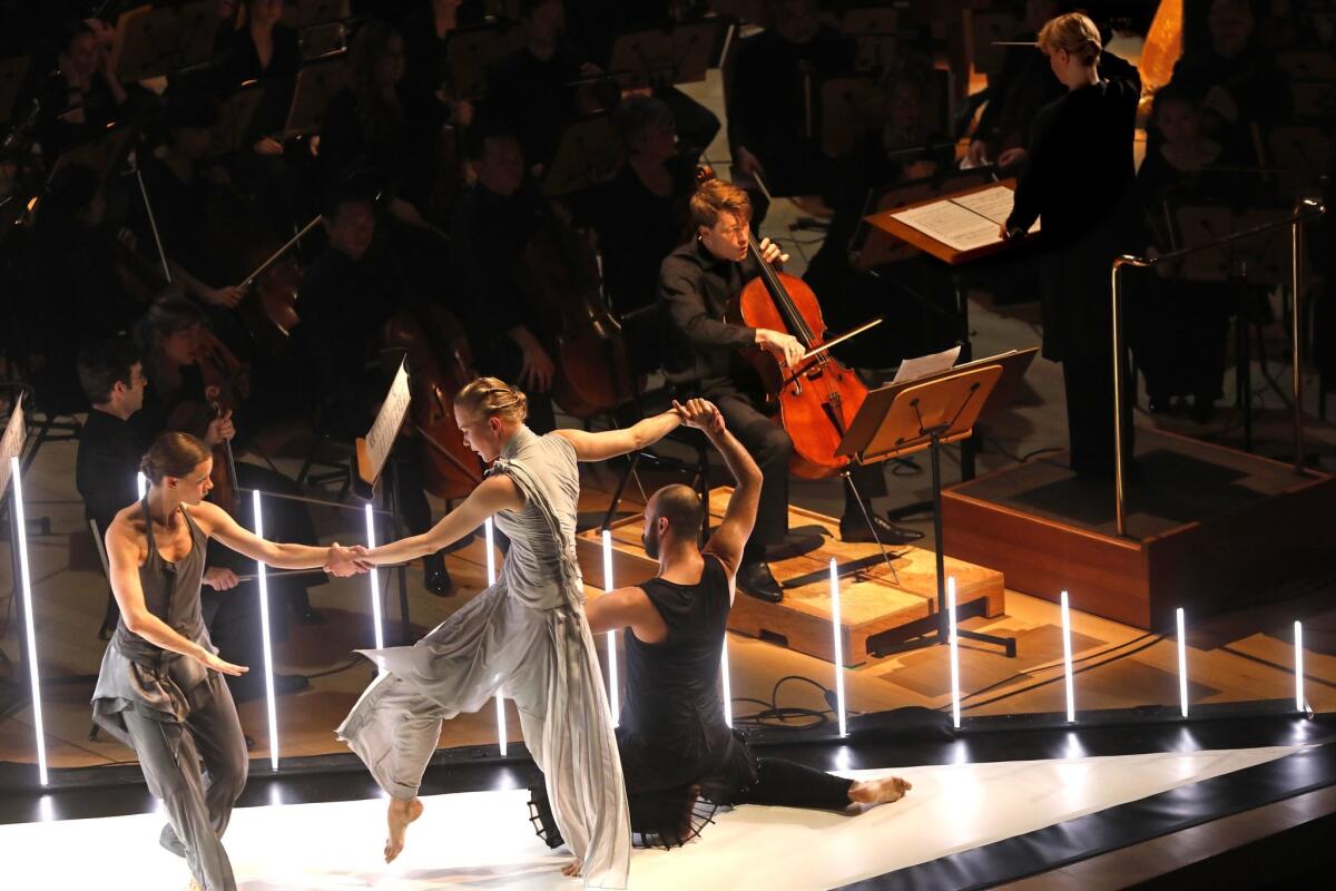 With the dancers in the foreground, cellist Eric Byers plays his solo.