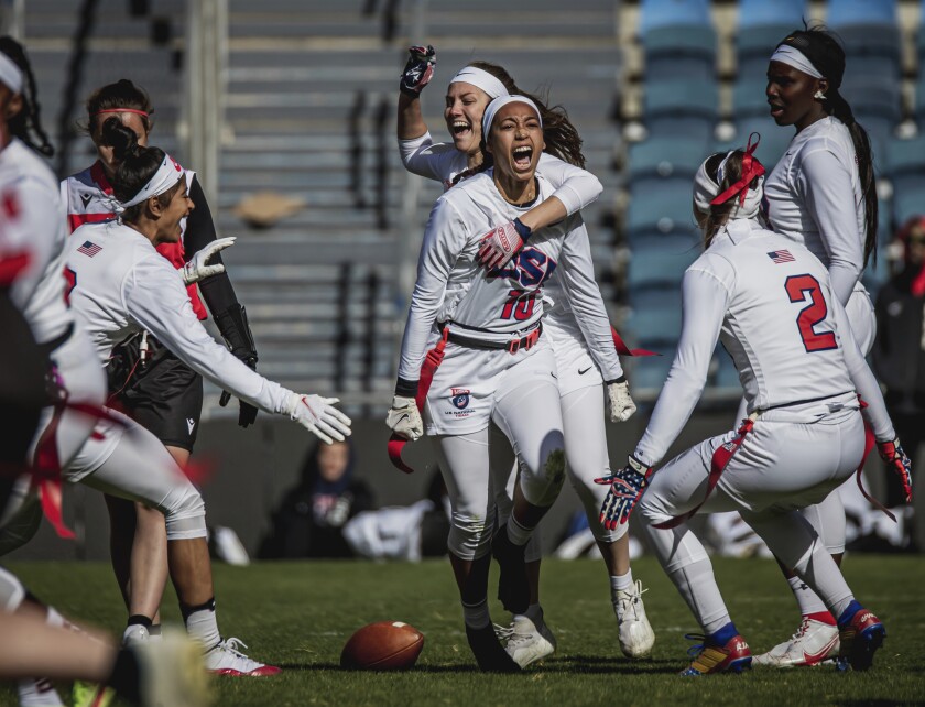 This handout provided by USA Football shows U.S. women's flag football team defensive back Deliah Autry (10) of Tampa, Fla., celebrating with teammates during a game against Austria at the International Federation of American Football Flag Football world championships in Jerusalem, Israel, Dec. 8, 2021. The NFL is helping wave the flag for flag football to become part of the Olympics. The target is the 2028 Summer Games in Los Angeles. (Adam Pintar/USA Football via AP)