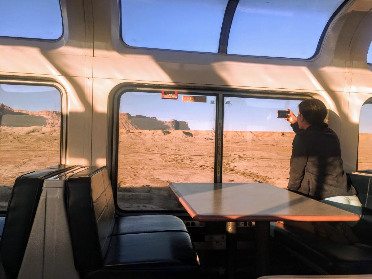 Passenger Erica Hendry takes photos of the Utah desert from her seat in the observation car of the California Zephyr.
