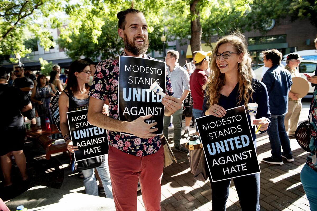 Shaun Gepley and Katy Forney attend a rally in Modesto last month to oppose the planned straight pride rally.