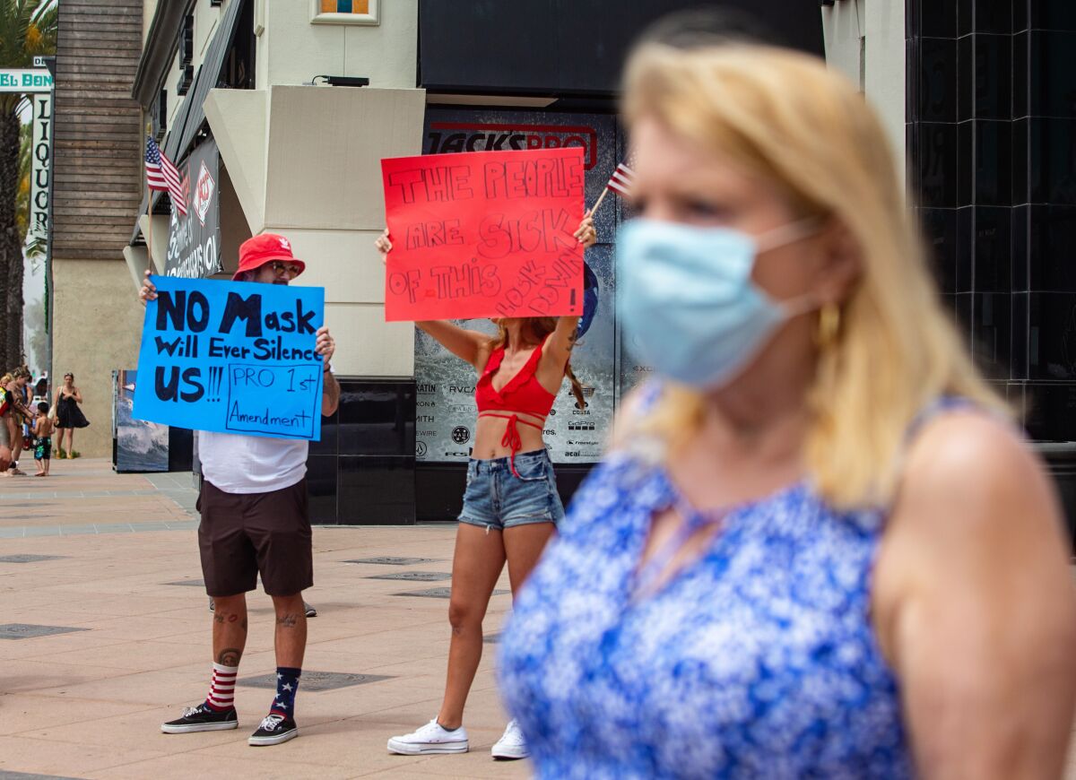 Demonstrators in Huntington Beach protest face mask rules.