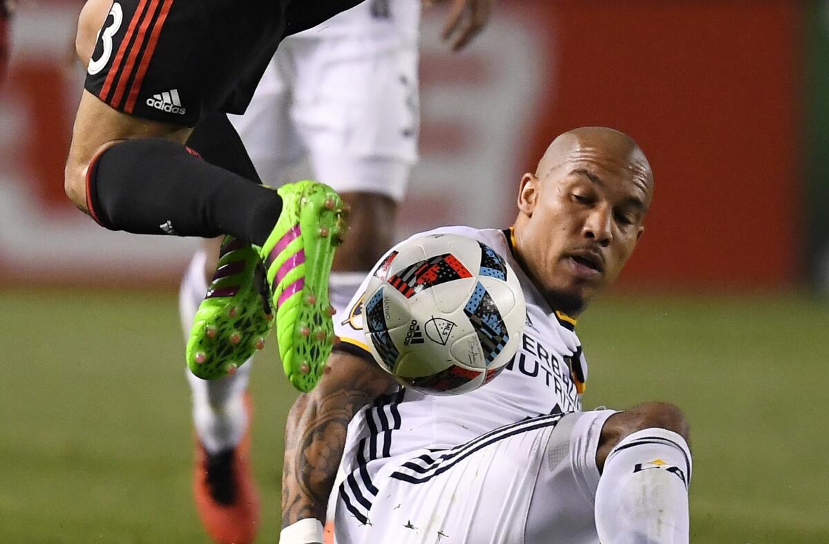 Galaxy midfielder Nigel de Jong slides to attempt a tackle during the first half of a game against D.C. United on March 6.