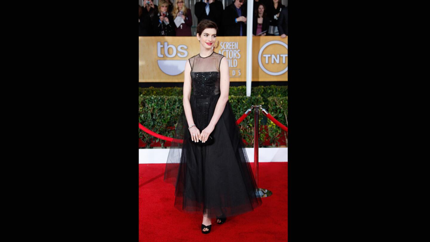 One of several anything-but-basic-black gowns, Hathaway's edgy Giambattista Valli creation, with corseted bodice, and full tulle skirt revealing a shorter skirt underneath, made her look like a modern-day Audrey Hepburn.