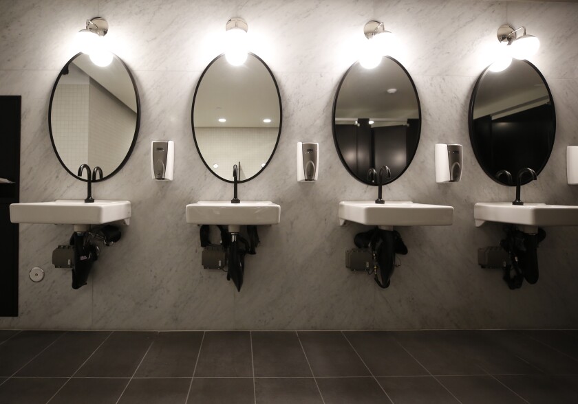 Original marble dividers from restrooms were repurposed for a wall backdrop in new restrooms.