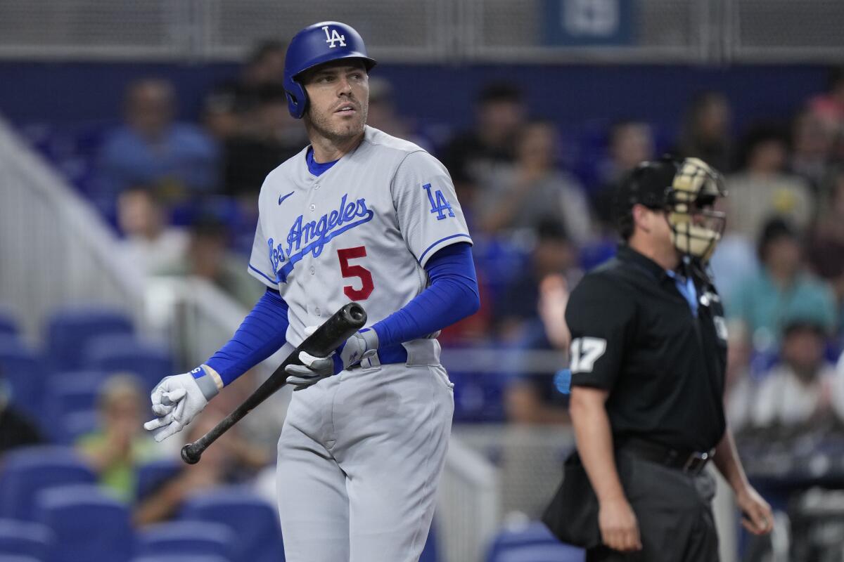 Freddie Freeman walks back to the dugout after striking out in the first inning against the Miami Marlins.