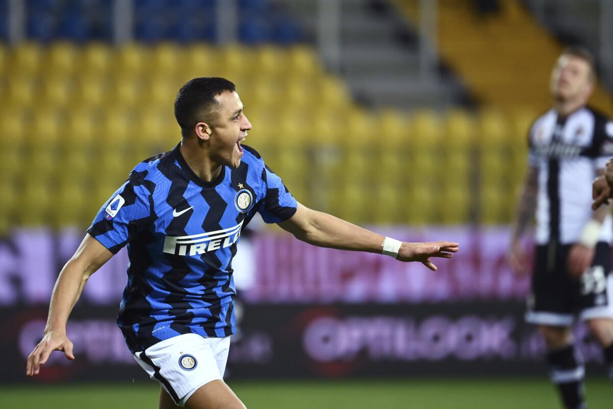 Inter's Alexis Sanchez celebrates after scoring during the Serie A soccer match between Parma and Inter Milan, at the Ennio Tardini Stadium in Parma, Italy, Thursday, March 4, 2021. (Massimo Paolone/LaPresse via AP)