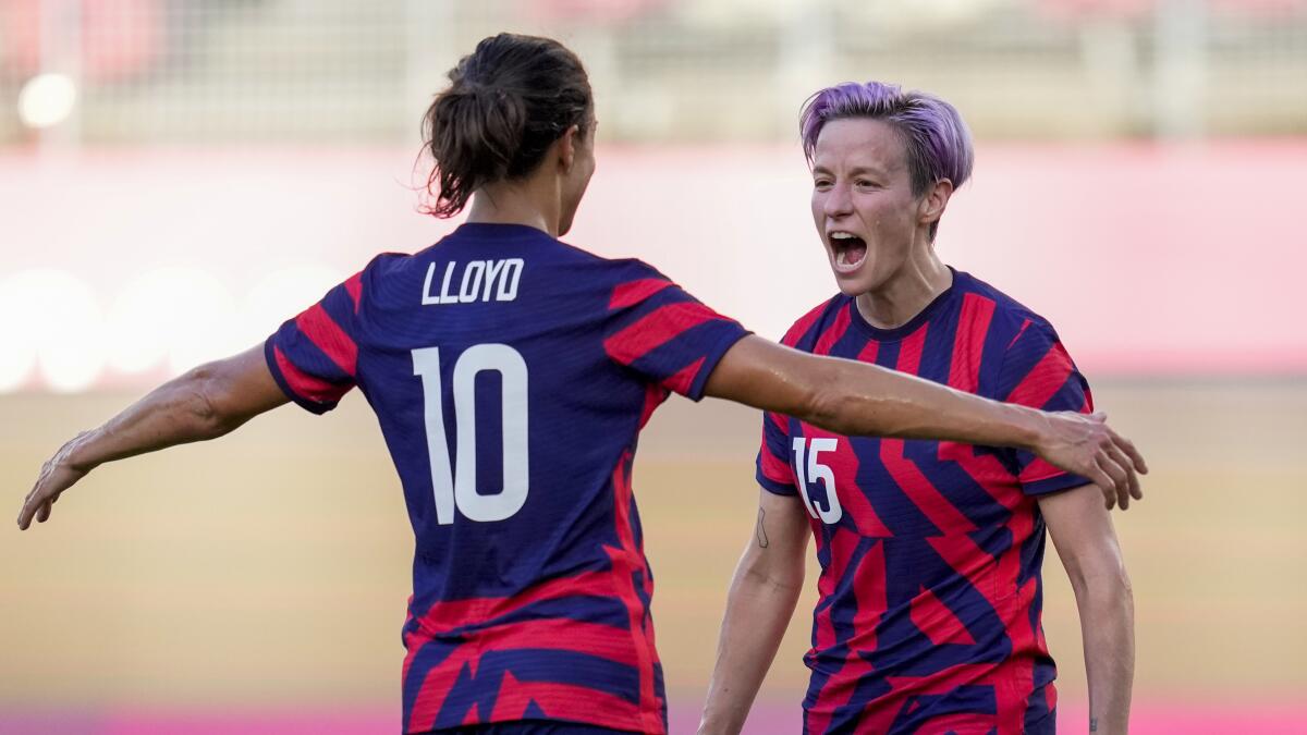 Carli Lloyd is about to hug Megan Rapinoe after a U.S. goal