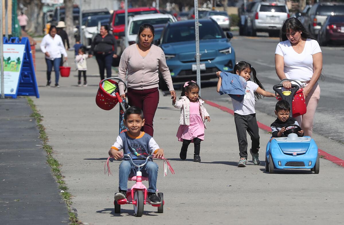 Huntington Beach resident Elia Hernandez, far right, lives in the local neighborhood with her kids.