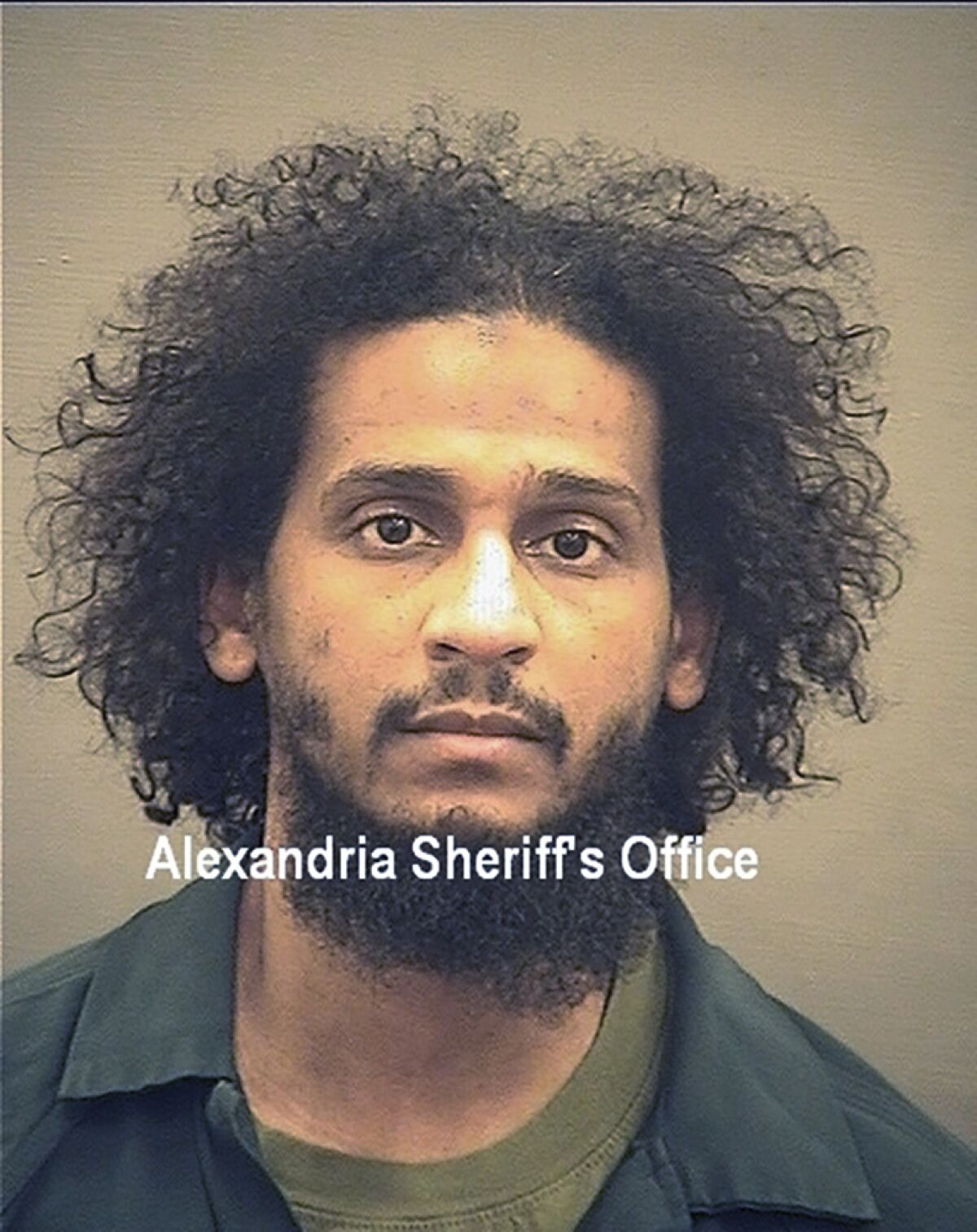 FILE - In this photo provided by the Alexandria Sheriff's Office is El Shafee Elsheikh who is in custody at the Alexandria Adult Detention Center, Wednesday, Oct. 7, 2020, in Alexandria, Va. Defense lawyers for the British national facing trial later this month for helping the Islamic State group torture and behead American hostages are seeking to block testimony from a Kurdish girl held as a slave by the group. The girl, identified only as Jane Doe in court documents, was abducted at age 15 from Kurdistan in August 2014 and held by the Islamic State.(Alexandria Sheriff's Office via AP)