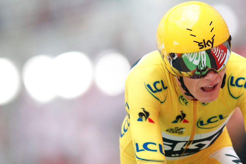 FILE - In this Saturday, July 22, 2017 file photo, Britain's Chris Froome, wearing the overall leader's yellow jersey, crosses the finish line during the twentieth stage of the Tour de France cycling race, an individual time trial over 22.5 kilometers (14 miles) with start and finish in Marseille, France. If Chris Froome enters next year's Giro dâItalia he'll have the chance to become the first cyclist to win the Tour de France, Spanish Vuelta and Giro in succession. âHe has to have the desire to try and become the first rider to achieve this feat," Giro director Mauro Vegni says in an interview with The Associated Press. (AP Photo/Christophe Ena, File)