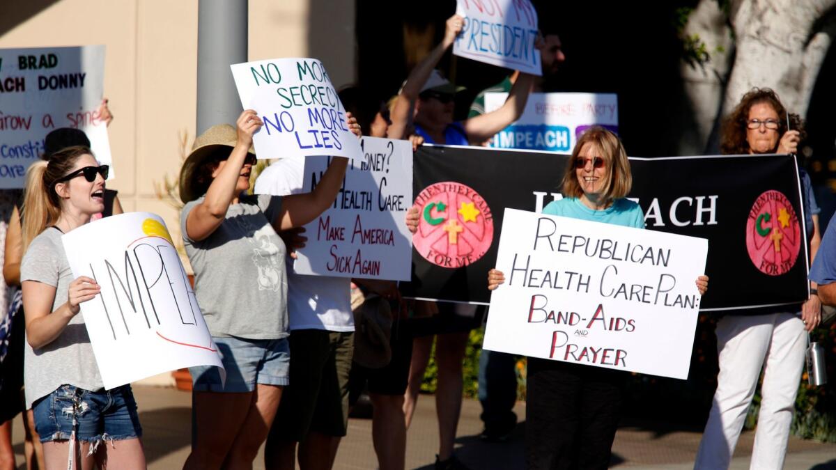 About 30 people gather to support Rep. Brad Sherman's impeachment attempt in front of his office in Sherman Oaks.