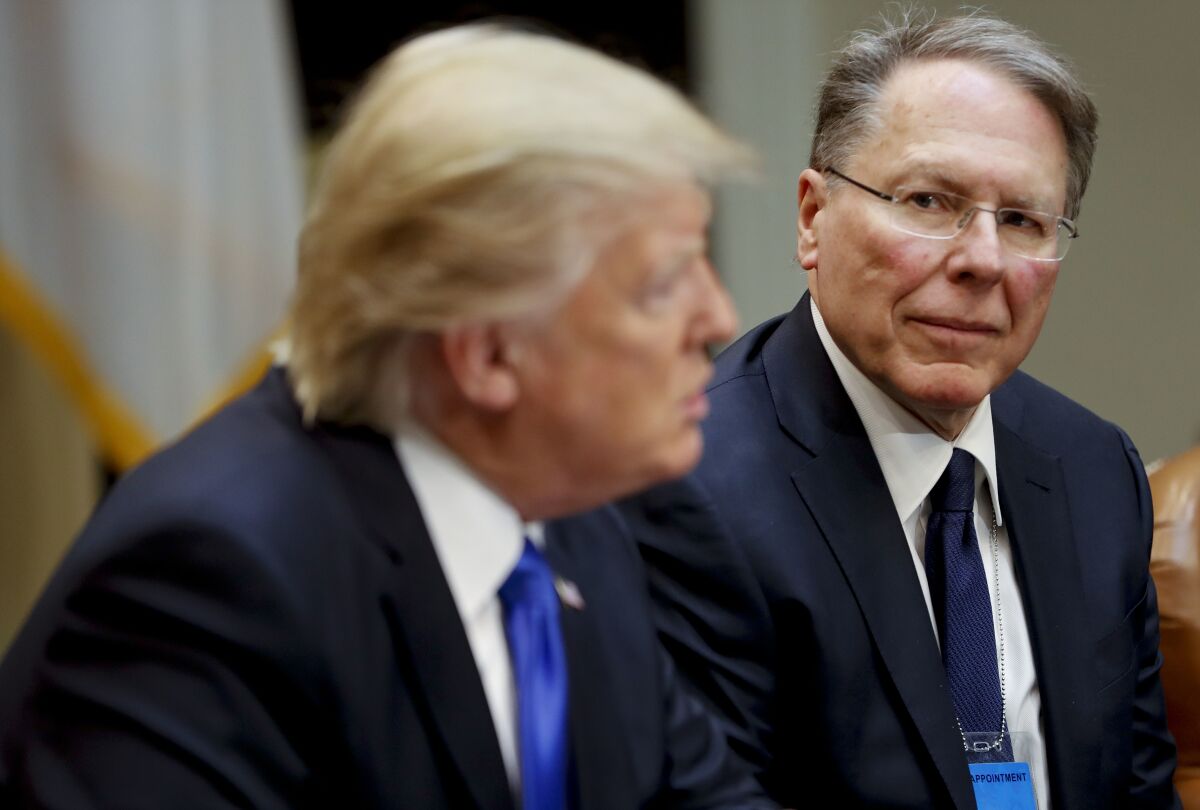 Wayne LaPierre, chief of the National Rifle Assn., listens as President Trump speaks in the White House shortly after taking office.