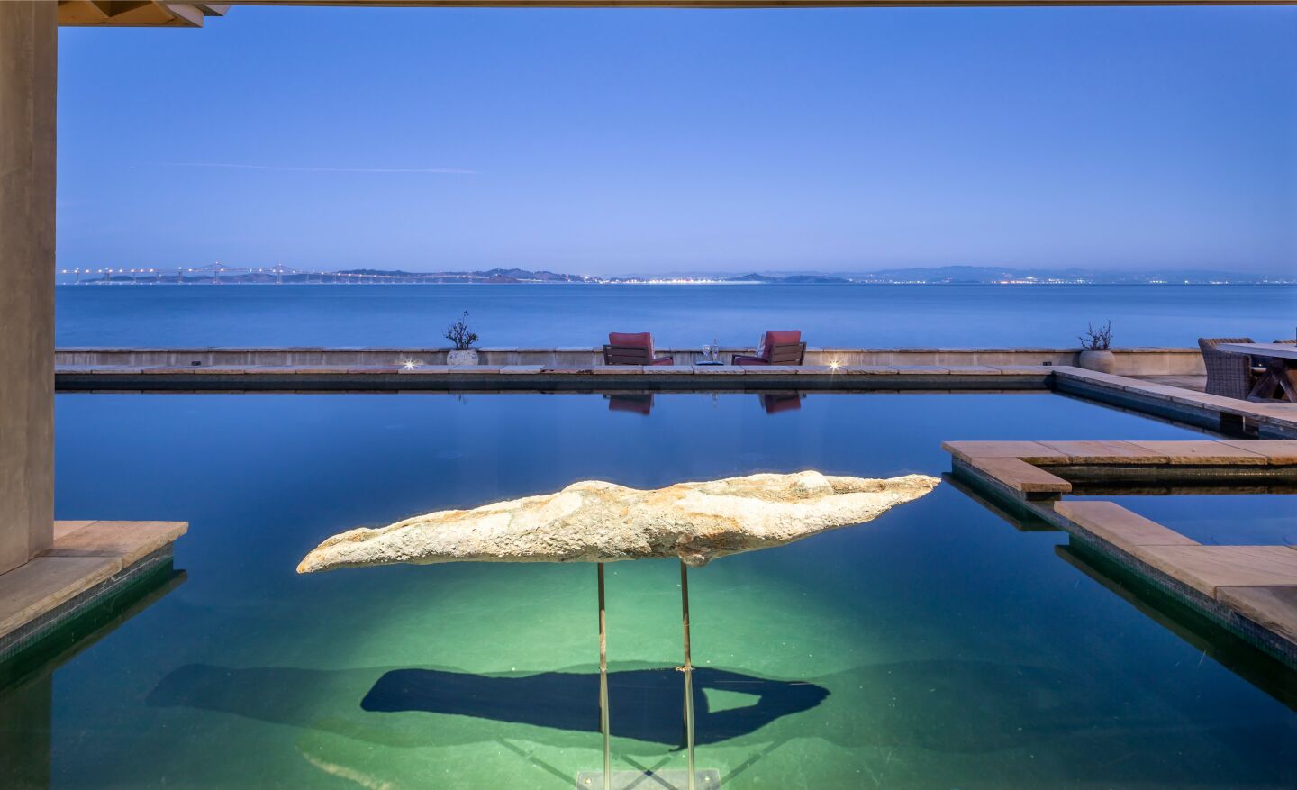 A statue of a swimmer suspended over the pool.