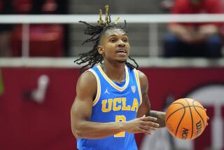 UCLA guard Dylan Andrews (2) brings the ball up court during the first half of an NCAA college basketball game against Utah Thursday, Jan. 11, 2024, in Salt Lake City. (AP Photo/Rick Bowmer)