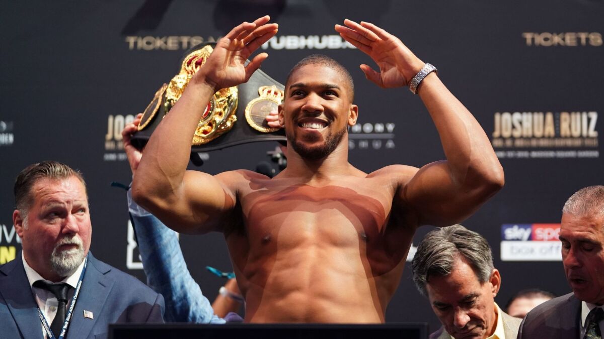 Heavyweight champion Anthony Joshua responds to cheers during his weigh-in at Madison Square Garden on May 31.