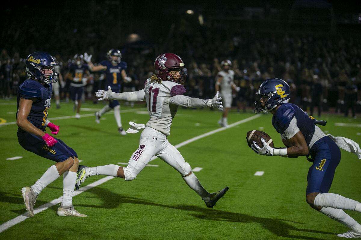 Crean Lutheran's Ty Benefield intercepts a pass intended for Laguna Beach's Jackson Rodriguez during a game on Friday.