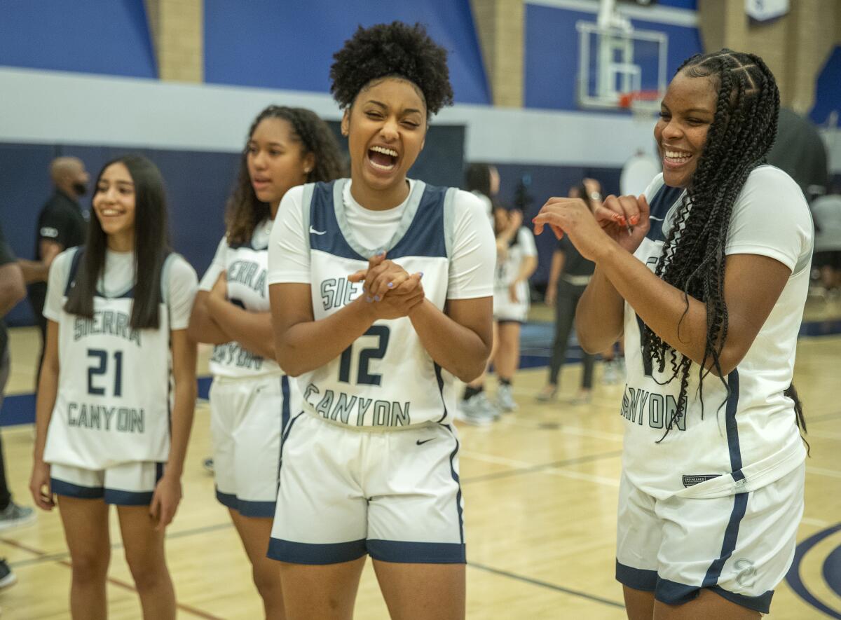 Juju Watkins and MacKenly Randolph share a light moment during Sierra Canyon's media day.