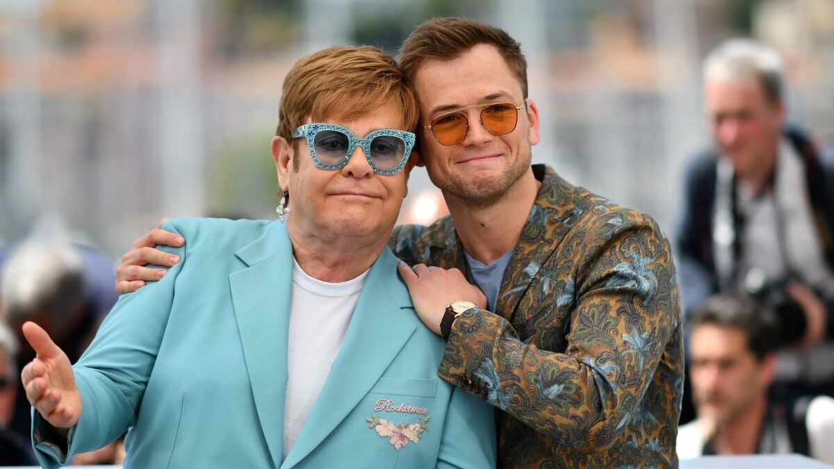 British singer-songwriter Elton John, left, and British actor Taron Egerton pose during a photocall for the film "Rocketman."