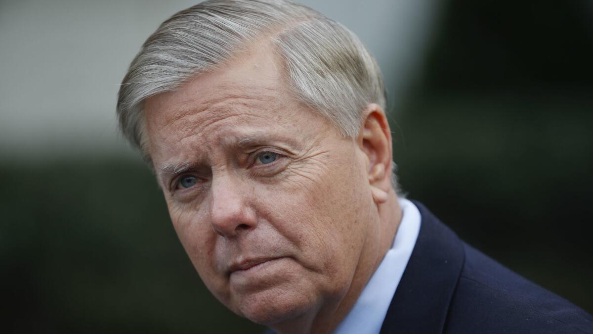 Sen. Lindsey Graham (R-S.C.) pauses while speaking to members of the media outside the White House on Dec. 30, 2018.