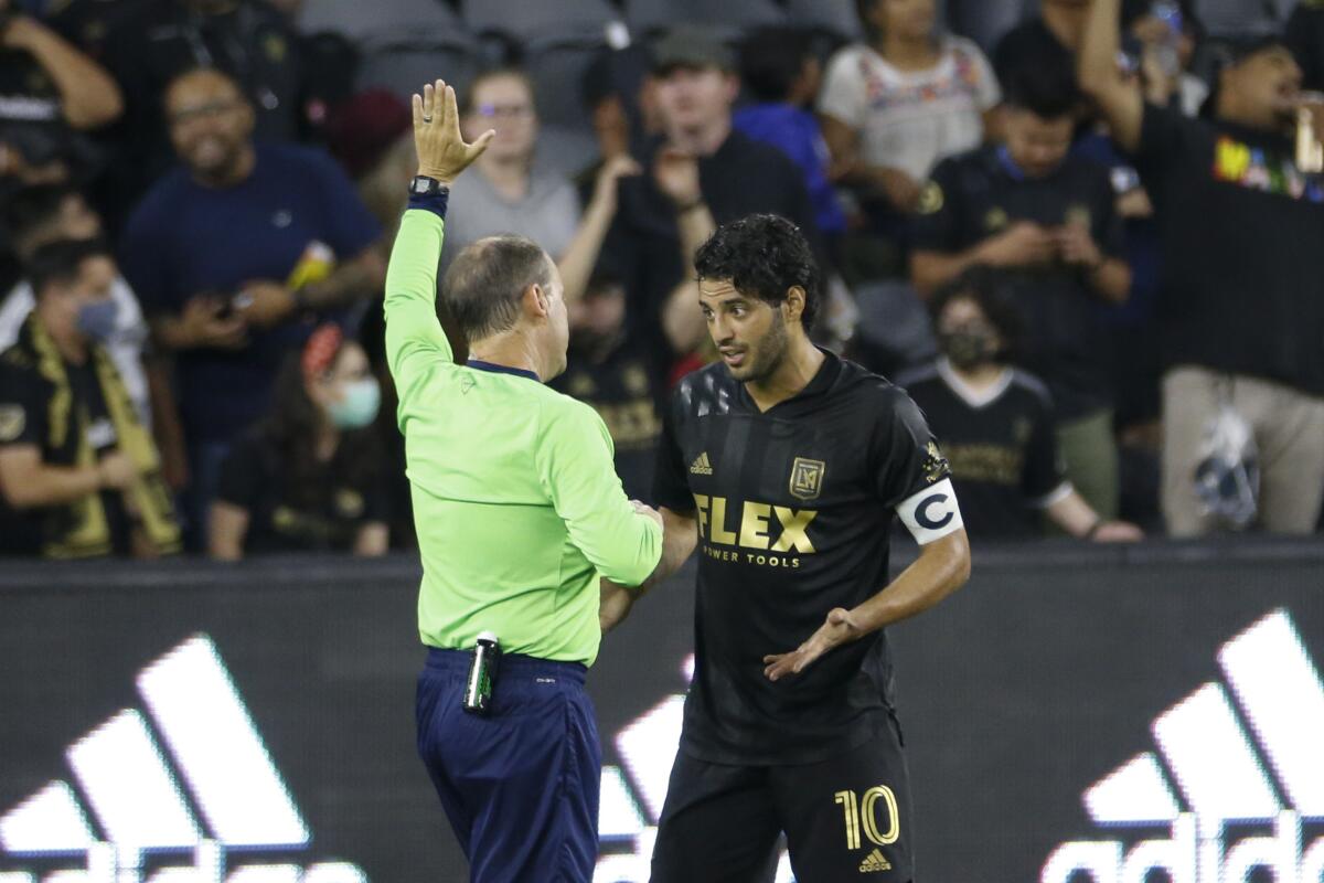LAFC forward Carlos Vela argues with a referee during a match 