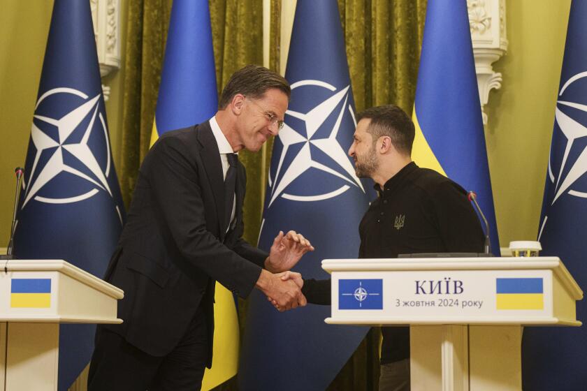 NATO Secretary General Mark Rutte, left, and Ukrainian President Volodymyr Zelenskyy, right, shake hands during press conference in Kyiv, Ukraine, Thursday, Oct. 3, 2024. (AP Photo/Evgeniy Maloletka)