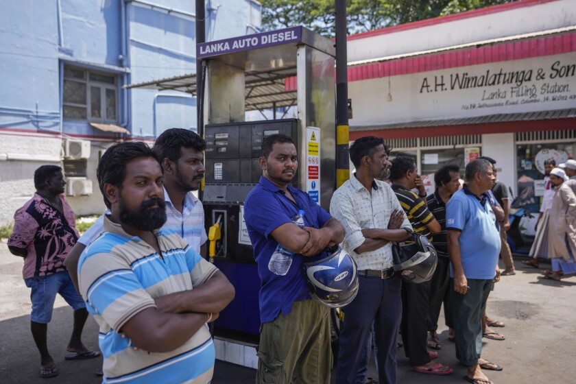 People wait to buy fuel at a fuel station in Colombo, Sri Lanka, Monday, June 27, 2022. Sri Lanka is sending two ministers to Russia to negotiate for fuel — one of the necessities that the Indian ocean island nation has almost run out of amid its ongoing economic crisis. (AP Photo/Eranga Jayawardena)