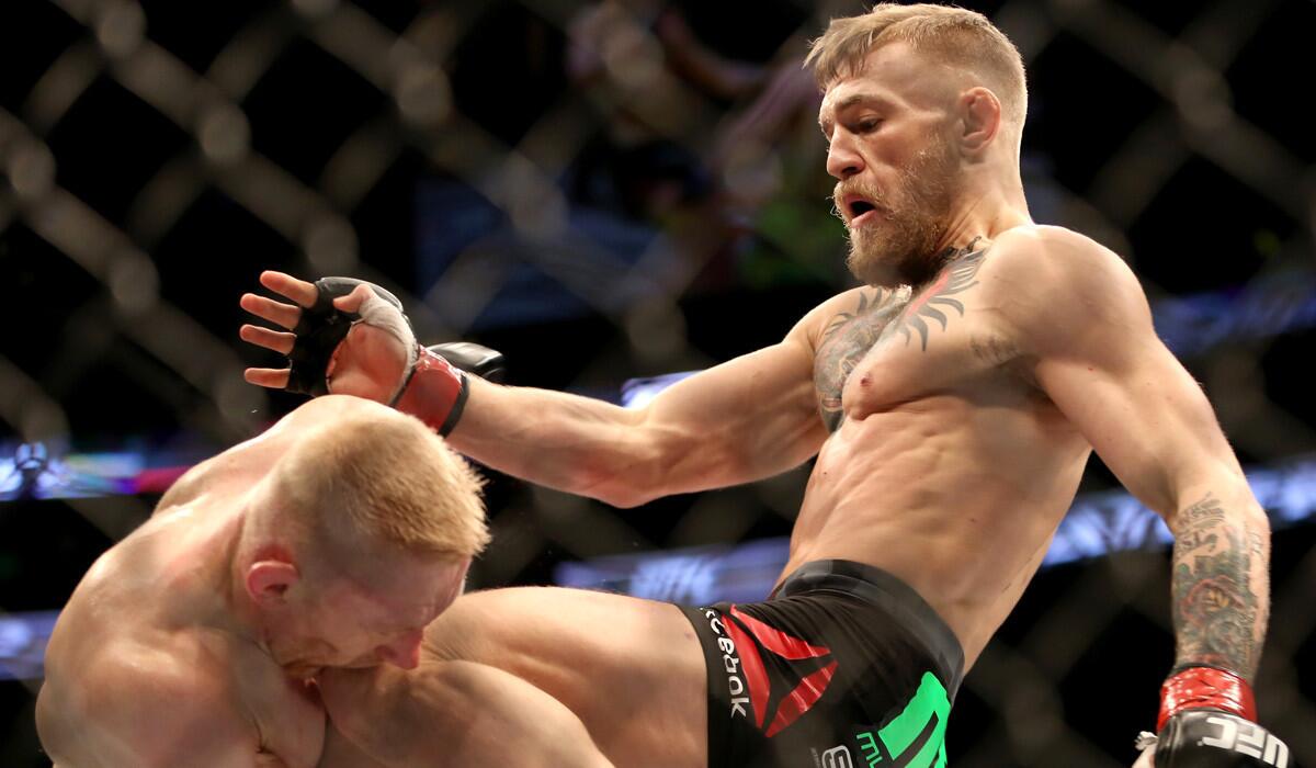 Conor McGregor, right, lands a knee against Dennis Siver during their featherweight fight at UFC Fight Night, in Boston. McGregor will fight Chad Mendes at UFC 189 in Las Vegas on Saturday.